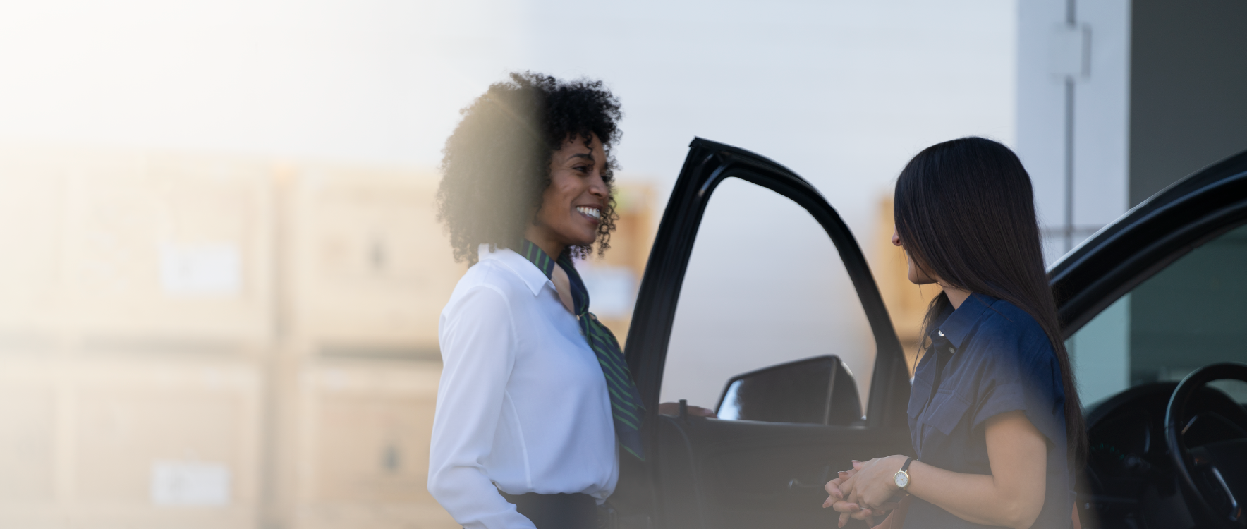 A person exits a GM vehicle while talking with a salesperson after taking a test drive.