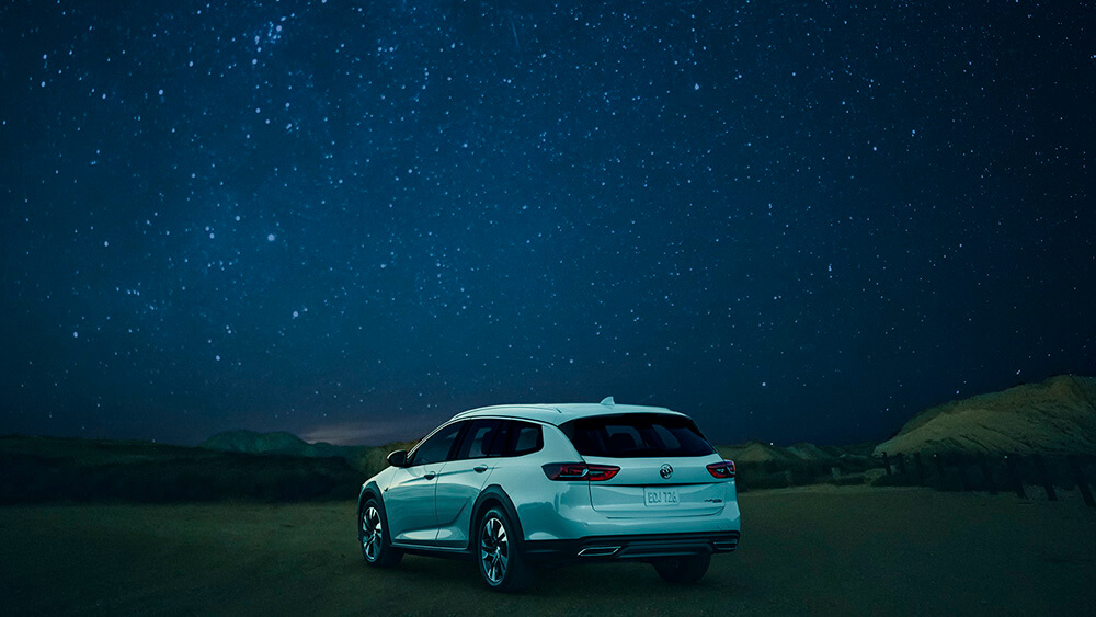 White SUV under a starry night after a night drive