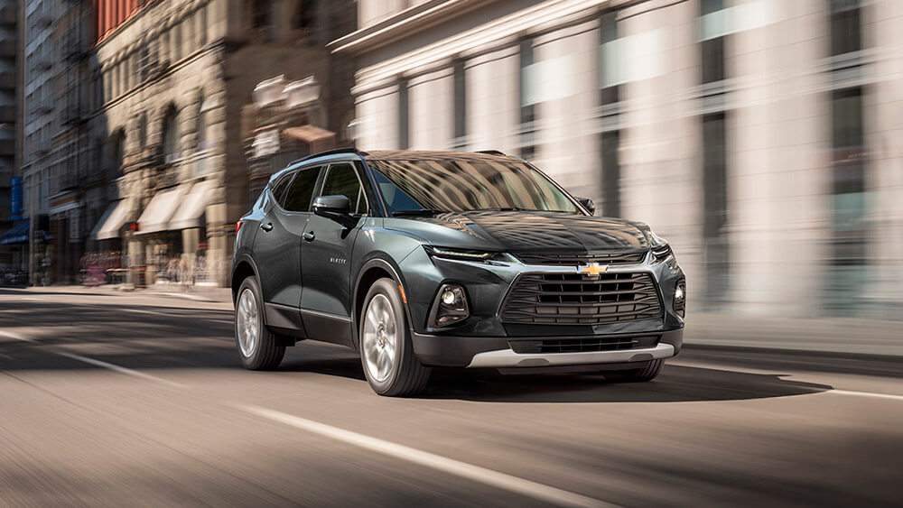 suv driving down a street during a test drive