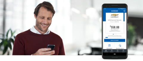 man smiling while using his phone, cell phone showing MyAccount screen.