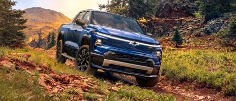 Blue Chevrolet Silverado EV on a on a rocky mountain road.