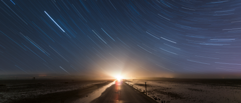 starlit night sky over scenic road