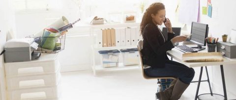 woman on the phone while working on personal finances