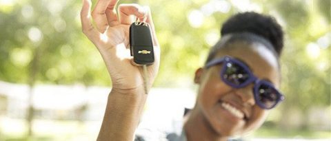 Woman smiling with a set of keys