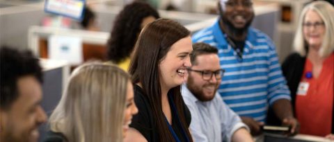 A diverse group of people laughing