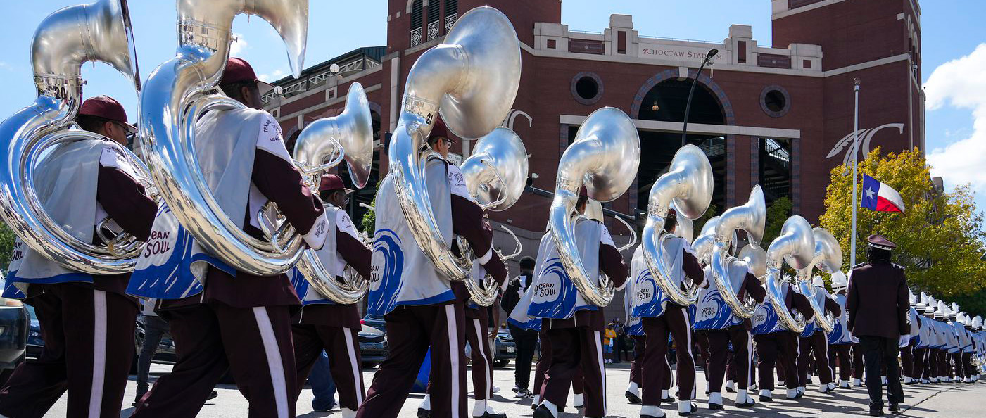 Marching band walking in front of Choctaw Stadium