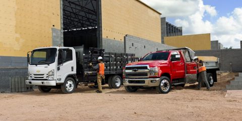 A Chevrolet cargo truck and a Chevrolet pickup at a construction site