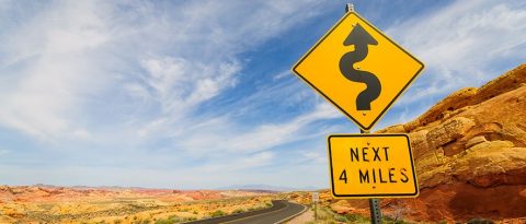 Curvy road sign on a desert road