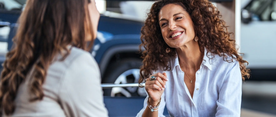 Woman preparing to buy a new car at a GM dealership.