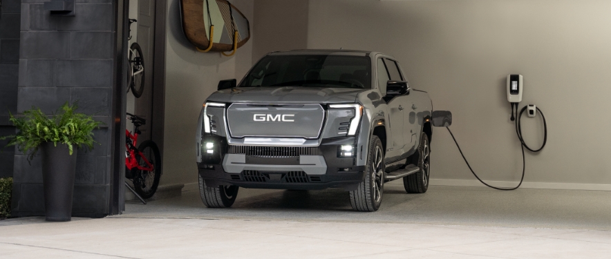 GMC Sierra EV Denali charging at home.